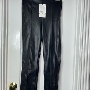 Black faux leather skinny pants with zipper bottoms. Brand new with tags